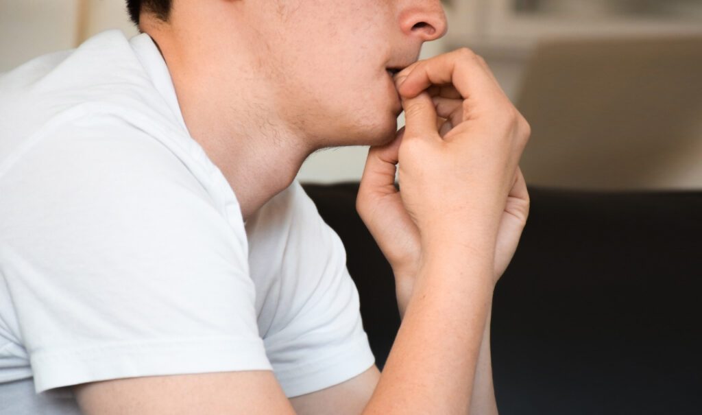 teenager biting their nails
