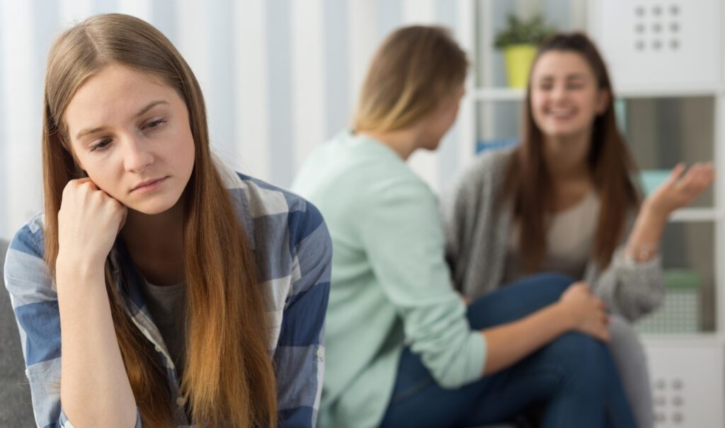 woman is sad about not being included in the chat